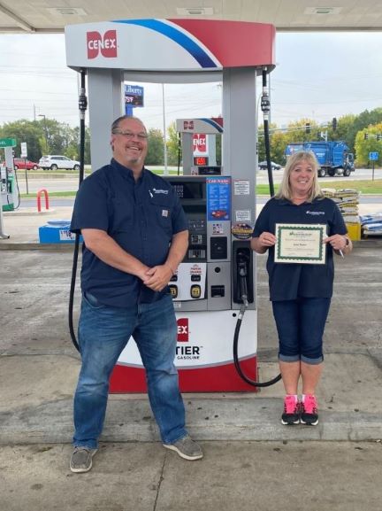 Troy Logan, at 6 feet, with Janet Salzer recognizing her 25 years of service